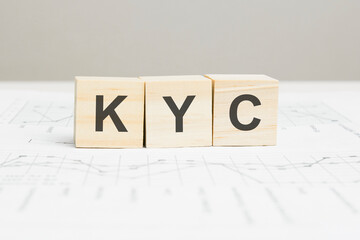 KYC wooden blocks word on grey background. KYC - Know Your Customer, information concepts