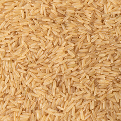 Closeup, top view of raw brown whole rice. Food backdrop
