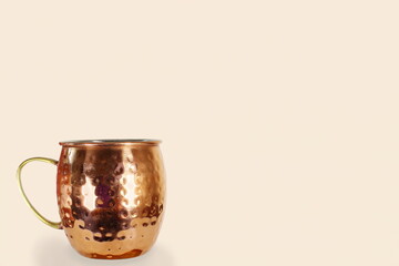 moscow mule copper cocktail mug isolated on cream pink background