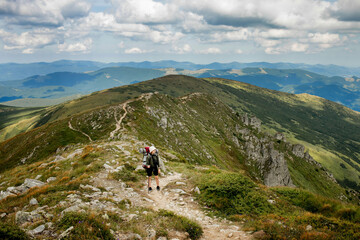 Fototapeta na wymiar Hiker on the top in Carpathians mountains. Travel sport lifestyle concept.