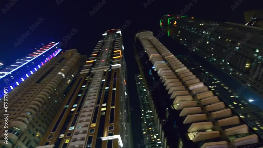 Wall mural DUBAI, UAE - DECEMBER 5, 2016: Walking along Dubai Marina at night with skyscrapers lights