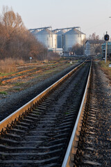 Obraz premium railway track near the factory. Autumn trees and factory premises