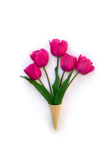 Pink tulips in waffle cone on white background with space for text. Top view, flat lay