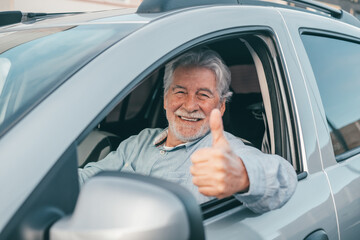 Happy owner looking at the camera with happy face and thumbs up. Handsome bearded mature man...