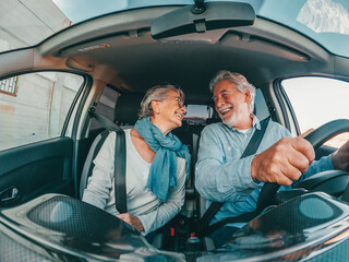 Couple of two happy senior having fun and enjoying vacations trip together driving and discovering...