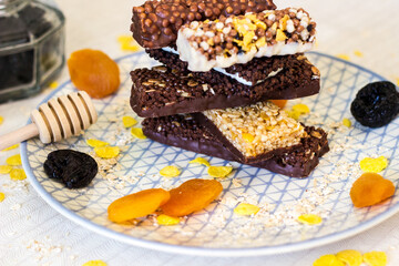 Granola energy bar with mix of nuts and fruits on a plate