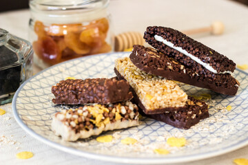 Granola energy bar with mix of nuts and fruits on a plate