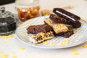 Granola energy bar with mix of nuts and fruits on a plate