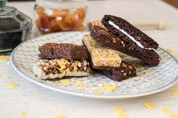 Granola energy bar with mix of nuts and fruits on a plate