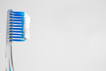 Blue toothbrush with white toothpaste