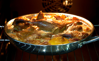 the duck lies in a skillet in the oven