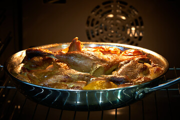 the duck lies in a skillet in the oven