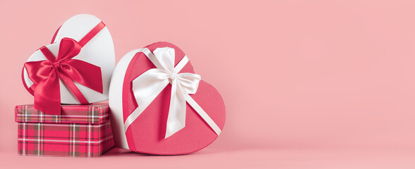 Bright packaging for purchases, gifts and parcels on a pink background. The concept of delivery of gifts and parcels for the holidays valentines day, pleasant surprises. Shopping, sale, promotion