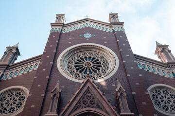 Saint Anthony's Church close up, the round windows of the church, its red walls