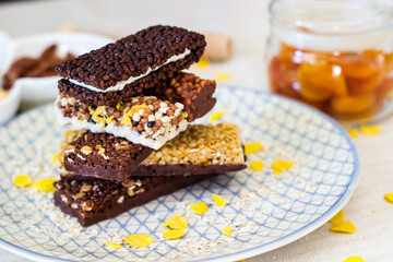 Granola energy bar with mix of nuts and fruits on a plate