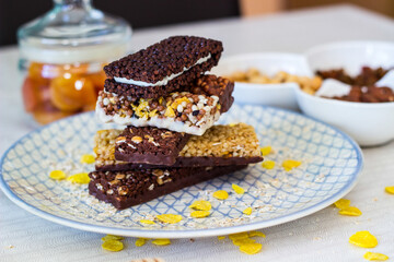 Granola energy bar with mix of nuts and fruits on a plate