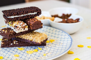 Granola energy bar with mix of nuts and fruits on a plate