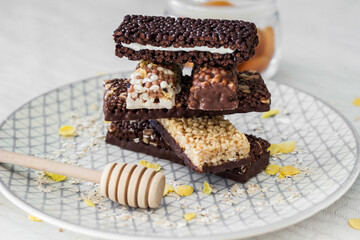 Granola energy bar with mix of nuts and fruits on a plate