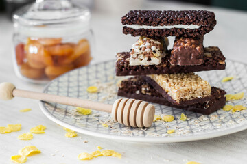 Granola energy bar with mix of nuts and fruits on a plate