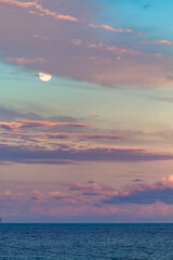 the moon and the sunset with colorful clouds