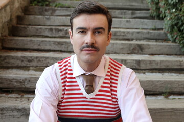 Classic looking man with a mustache, tie and knit vest