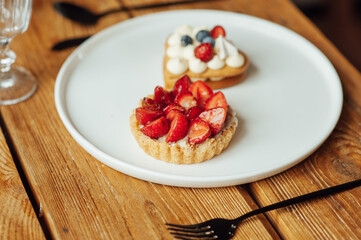 Fresh healthy breakfast in bed with cookies and strawberries