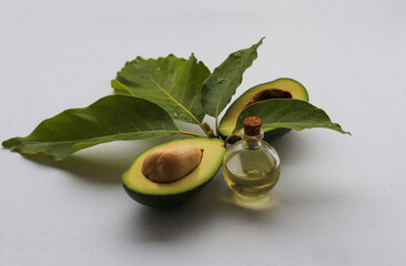 Oil and ripe fresh avocado oil on the table, close-up