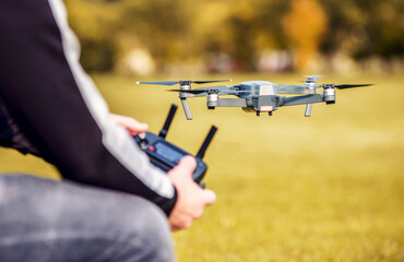 Man with flying drone, close up photo. Concept of cybernetics and robotics