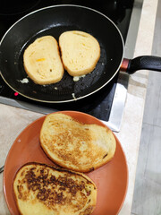cooking fried croutons in a pan, top view