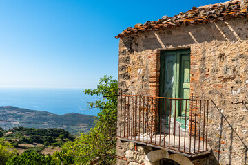 Balcony of an old house with view on the mediterranean sea, Sicily, Italy