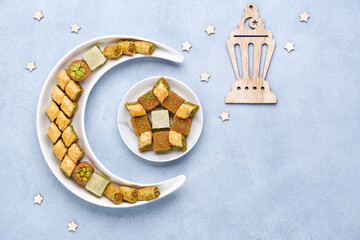 Traditional middle eastern dessert baklava in shape of moon and star . Ramadan background with...