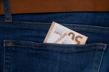 Money in blue jeans pocket