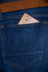 Money in blue jeans pocket