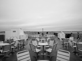 Black and white image of the forward sitting area on the passenger-car ferry in winter