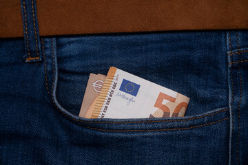 Money in blue jeans pocket