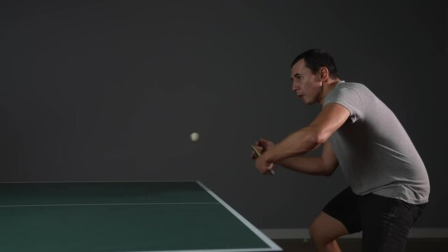 table tennis. man a athlete playing ping pong. sport party tournament concept. sportsman man training playing table tennis. forehand lifestyle and backhand exercise in ping pong