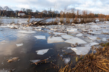 Close up view of ice drift on the frozen river. Melting ice. Flooded road. Concept of spring floods