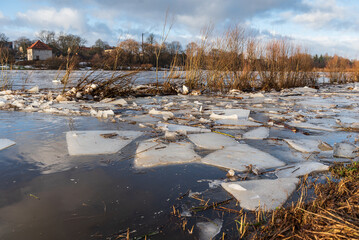 Close up view of ice drift on the frozen river. Melting ice. Flooded road. Concept of spring floods