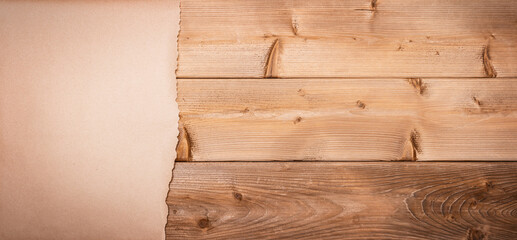 Wooden background with paper for the place of your advertisement