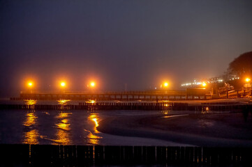 Wooden groynes and light - night photograph