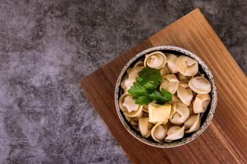 Top view of traditional russian dish pelmeni or dumplings with meat.