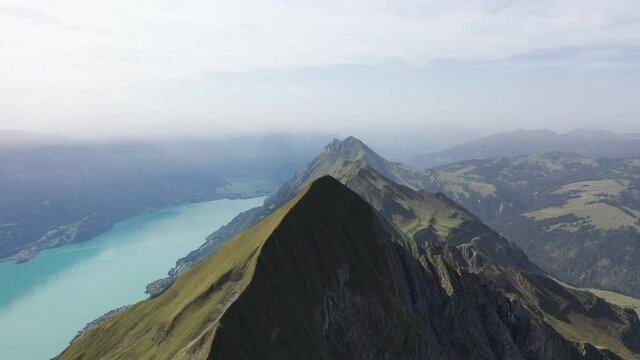 Amazing footage over the beautiful places in Switzerland. A wonderful areal flight at a sunny day in the alps. Epic drone flight over the beautiful mountains at the lake Brienz called Brienzergrat.