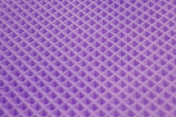 waffle cake close up. violet checkered background. geometric volumetric texture.