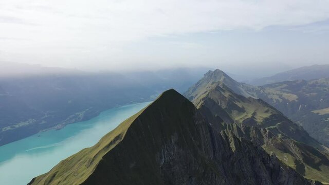 Amazing footage over the beautiful places in Switzerland. A wonderful areal flight at a sunny day in the alps. Epic drone flight over the beautiful mountains at the lake Brienz called Brienzergrat.