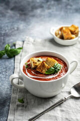 Traditional homemade gazpacho cold soup. Tomato soup puree served seafood on a stone background. Copy space.