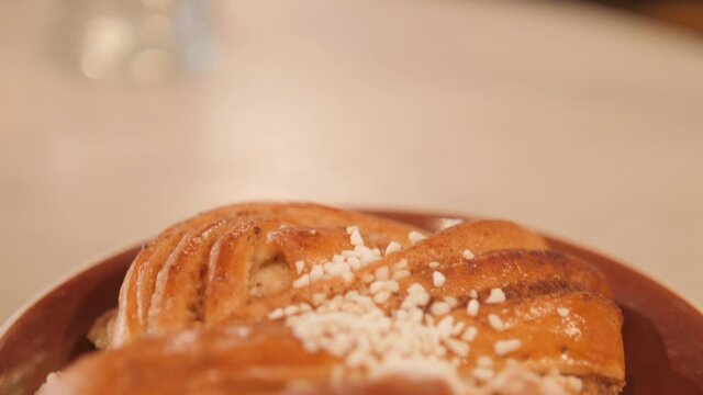 Safran Bulle Bun In White Plate from a Bakery, Traditional Delicacy In Stockholm, Sweden.