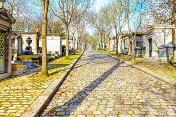 Path in cemetery . Pere Lachaise Cemetery . Pavement and crypts in the graveyard