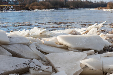 Close up view of ice drift on the frozen river. Melting ice. Stack of ice. Concept of spring floods
