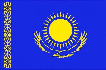 The flag of the Republic of Kazakhstan with the image of the sun and a flying bird in yellow on a blue background.