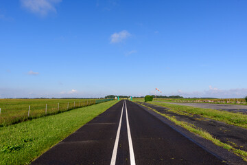 The main road past the traditional French village of Saint Sylvain in Europe, France, Normandy, towards Veules les Roses, in summer on a sunny day.